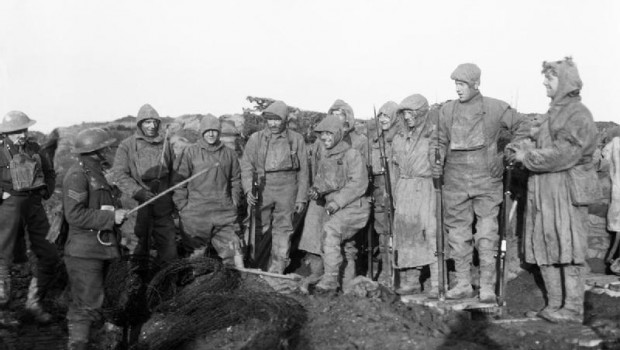 Men of the York and Lancashire Regiment, wearing camouflage suits, prepare for a trench raid near Roclincourt, 12 January 1918.